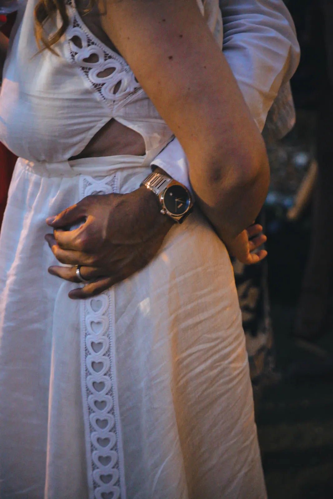 La main de Manan sur la taille de Chloé, détail de la robe